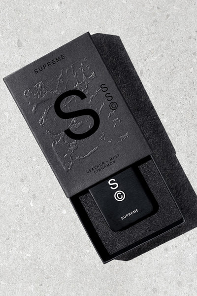 Solid State - Supreme by Solid State is a sleek black box with a bold S©, containing a matching black solid state cologne embossed with the logo. This wax-based scent features notes of leather, mint, and cinnamon.