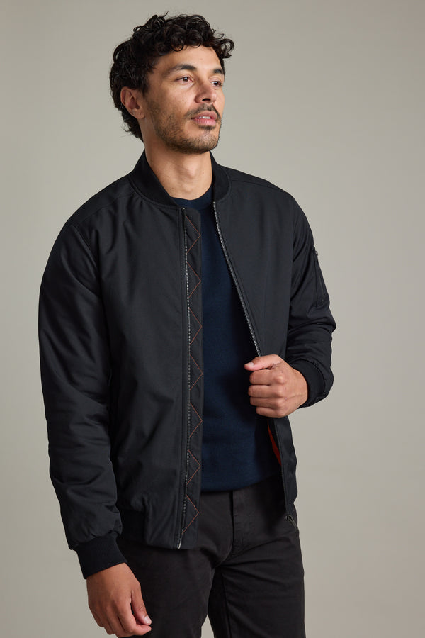 Man wears Barkers Dunhill Bomber Jacket with dark pants against a plain background.