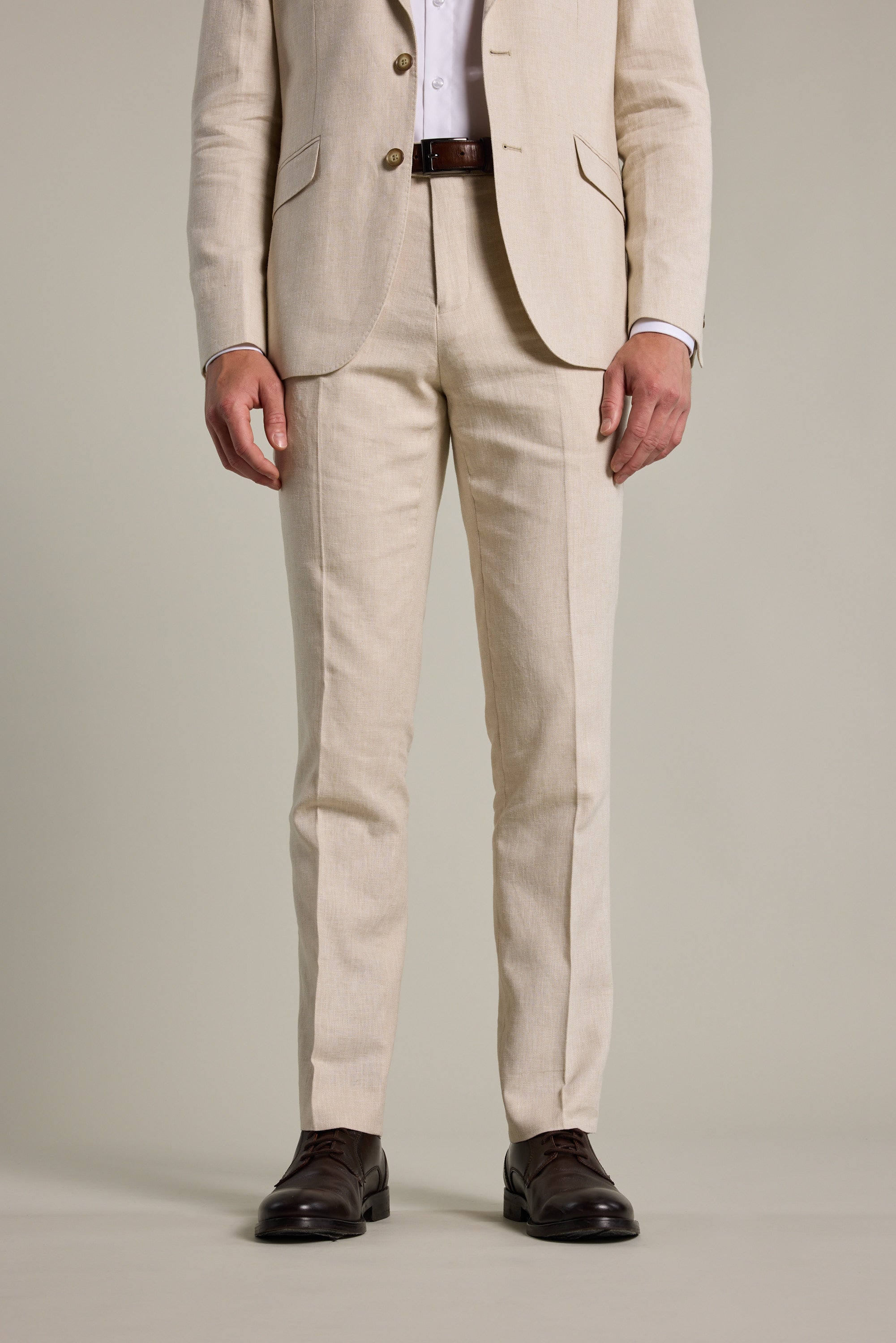Man in Barkers William Texture Linen Pant, white shirt, dark brown shoes, standing upright.