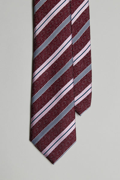 The Gracie Stripe Tie by Barkers is shown in a close-up, featuring maroon with light pink and dark gray diagonal stripes against a plain light gray background.