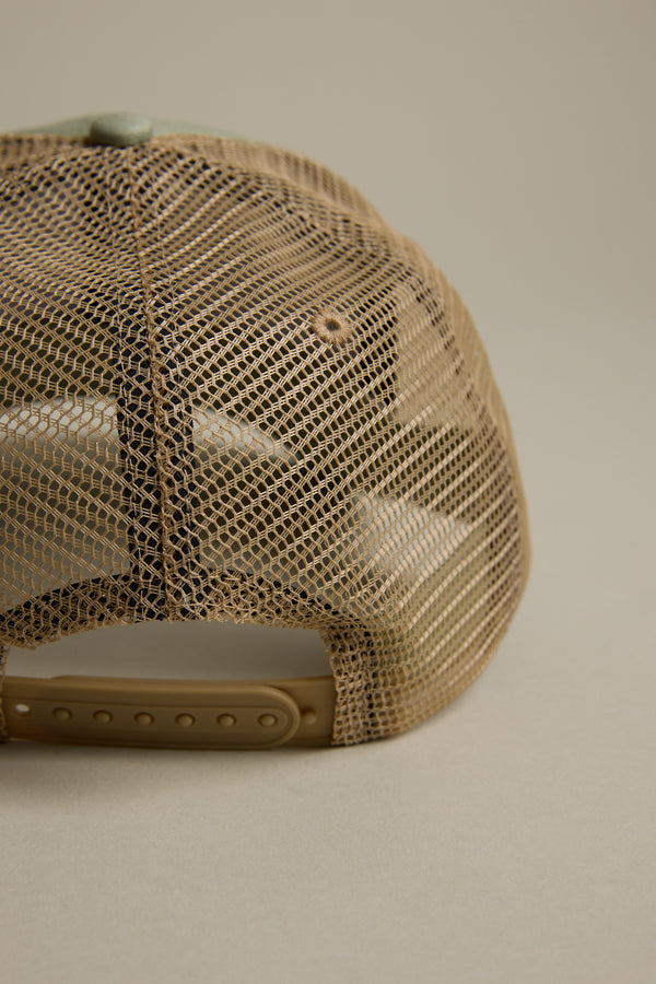 Close-up of the back of the tan mesh Legasea FFS Trucker Cap by Legasea, featuring an adjustable snapback strap against a neutral background. This classic trucker hat is ideal for fans of the Legasea collection.