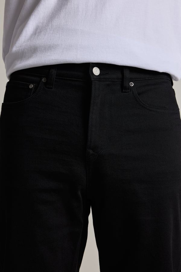 Waist-down view: person in Barkers Drifter Denim Relax Jean and a white t-shirt.