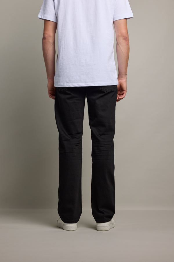 Person facing away, wearing Barkers Drifter Denim Relax Jean and a white t-shirt.