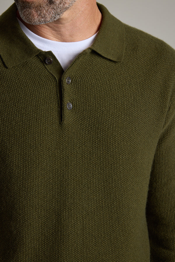 Man wearing the Barkers Ainsley Woollen Long Sleeve Polo in olive over a white T-shirt.