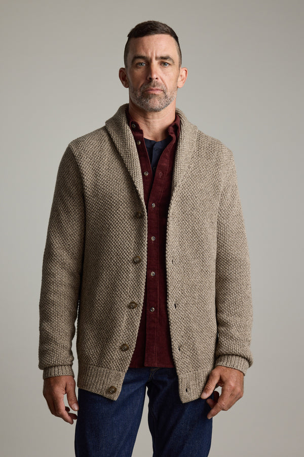 Man in Barkers Rudder Cotton Shawl Cardi over a burgundy shirt and jeans, ideal for winter.