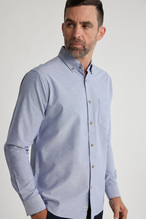 A man with short dark hair and a beard wears the Barkers Thatcher Oxford Shirt, featuring a chest pocket and made from responsibly sourced cotton. He is turned slightly to the side against a plain, light background.
