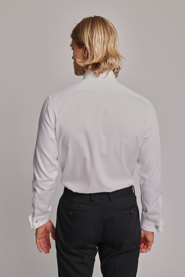 Blonde man in a Barkers Eldridge Dress Shirt and black pants, seen from the back.