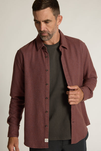 Man in a Barkers Raleigh Oxford Overshirt of responsibly sourced cotton, looking down.