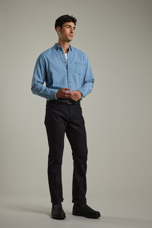 Man wears Barkers Avalon Denim Shirt with black jeans and black boots.