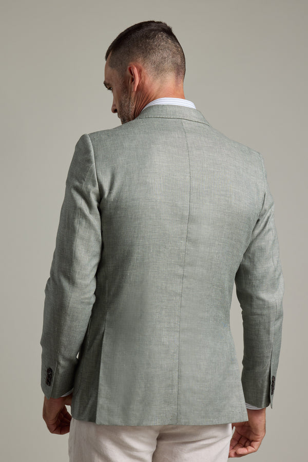 A man with short hair and a trimmed beard is seen from the back, wearing the Barkers Marion Texture Blazer in light gray and white pants, standing against a plain light gray background.