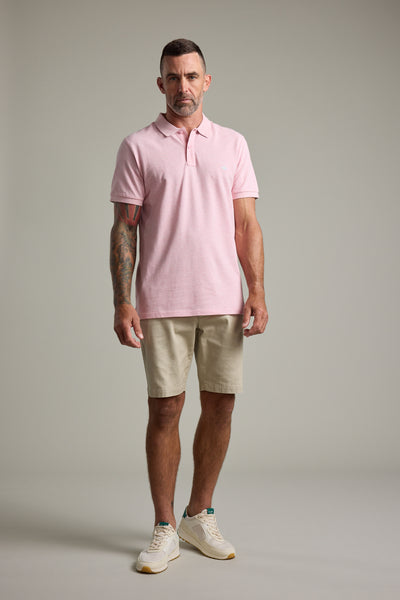 Man in Barkers Regent Pique Polo, beige shorts, and sneakers.