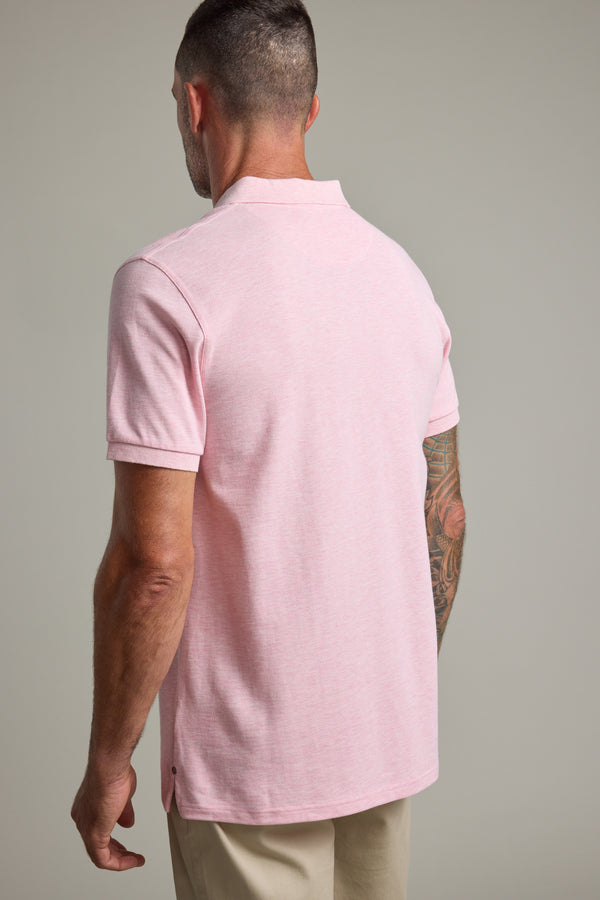Man with short hair and tattoo in a light pink Barkers Regent Pique Polo, seen from the back.