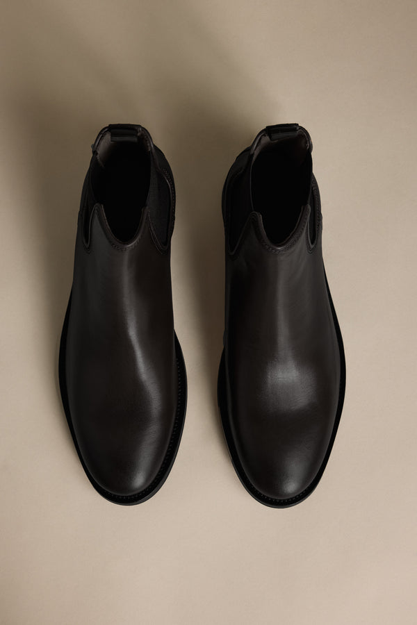 The Barkers Peter Chelsea Boot in black leather on a beige background, viewed from above.
