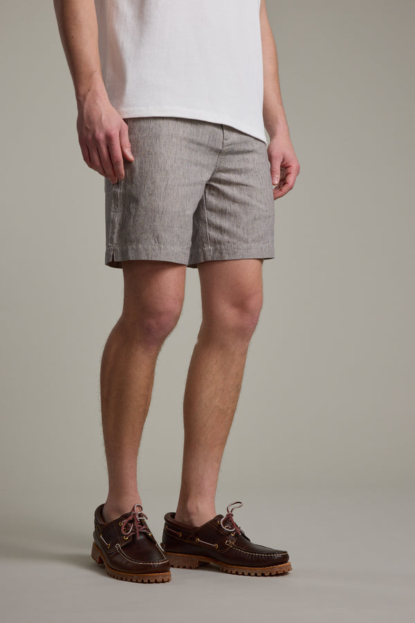 A person is shown from the shoulders down wearing Barkers' Woodley Weekend Short in light gray, styled with a white t-shirt and brown boat shoes, standing against a plain background.