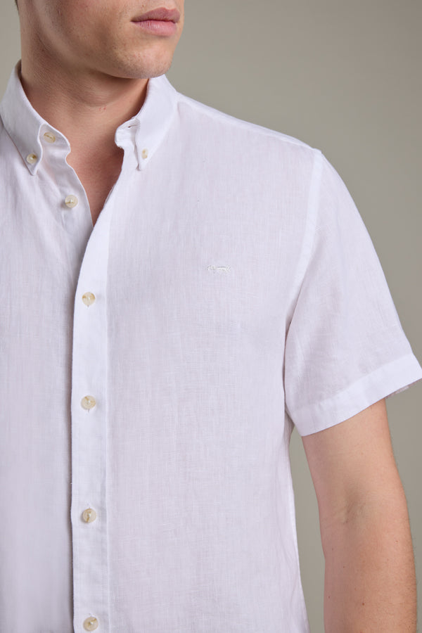Man wears Barkers Gentry Linen Shirt, white, short-sleeve, shown shoulders to waist.