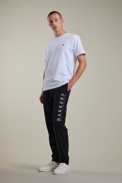 Man in white tee and Barkers Organic Classic Print Track Pant stands against a plain background.