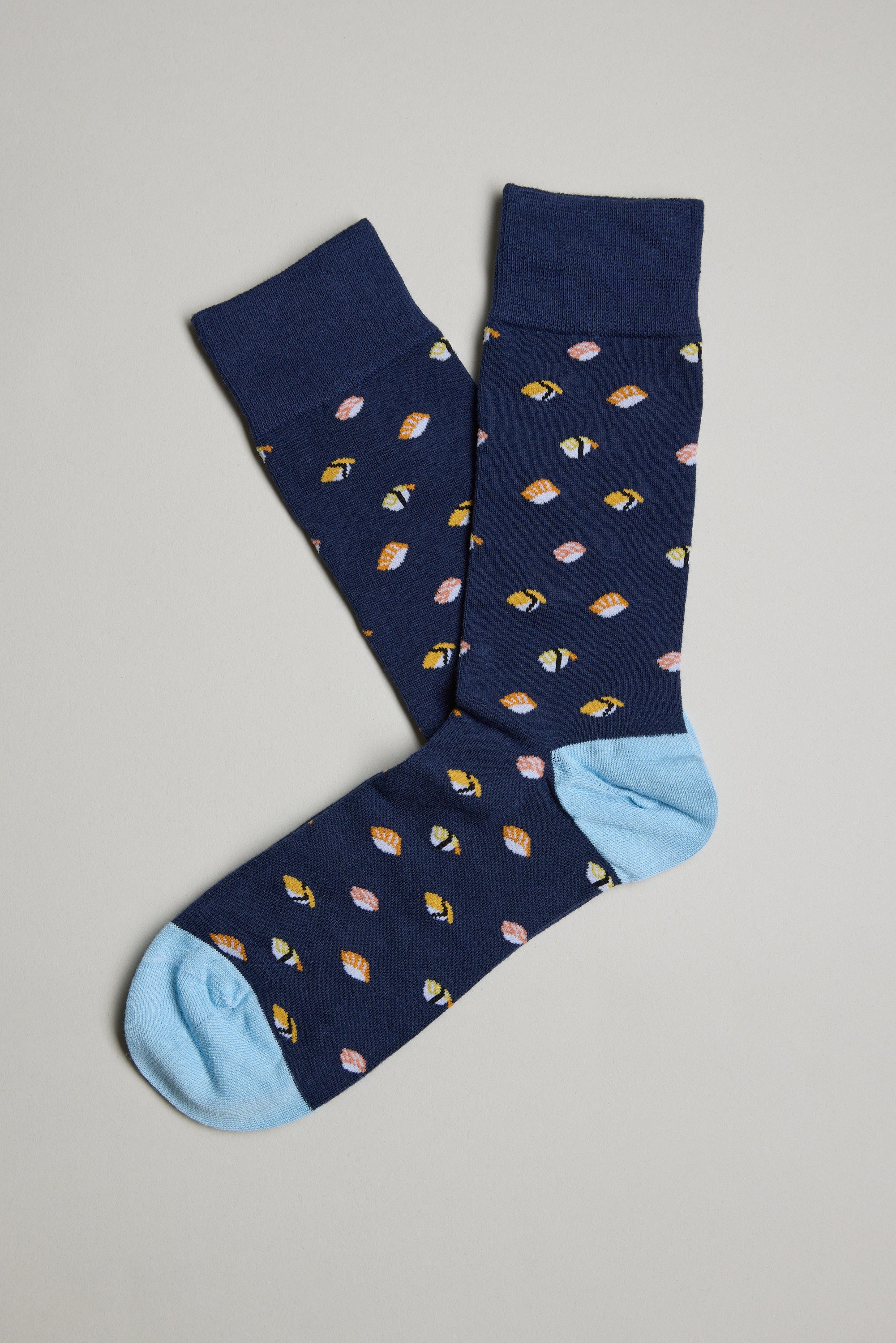 The Barkers Freshport Sushi Sock features a fun navy blue design with light blue toe and heel, plus a colorful all-over print of small leaves in yellow, pink, and orange. Displayed flat on a neutral background.