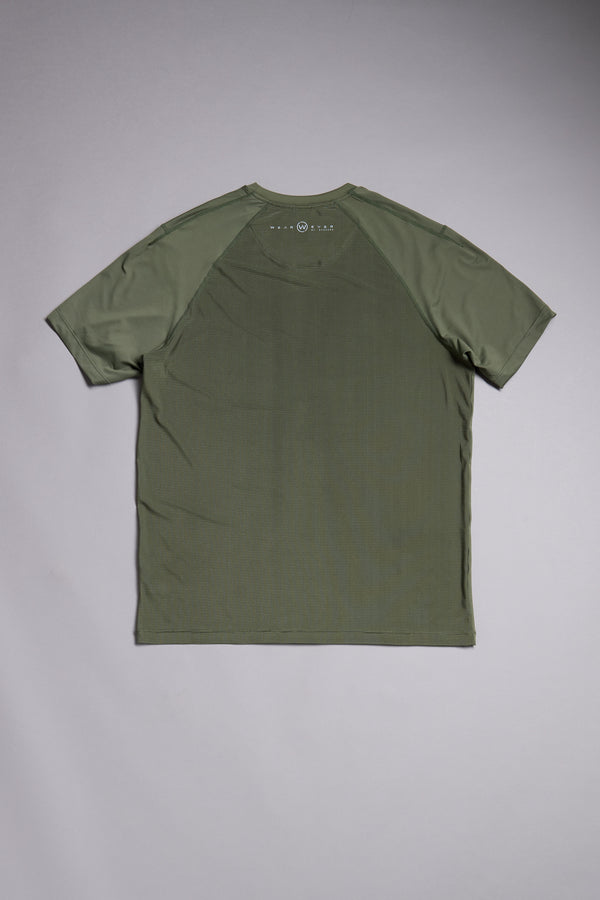The WearEver Pulse Tee by WearEver, shown in olive green on a light gray surface from the back, features raglan sleeves, a subtle printed logo near the neckline, and is ideal for moisture-wicking workout performance.