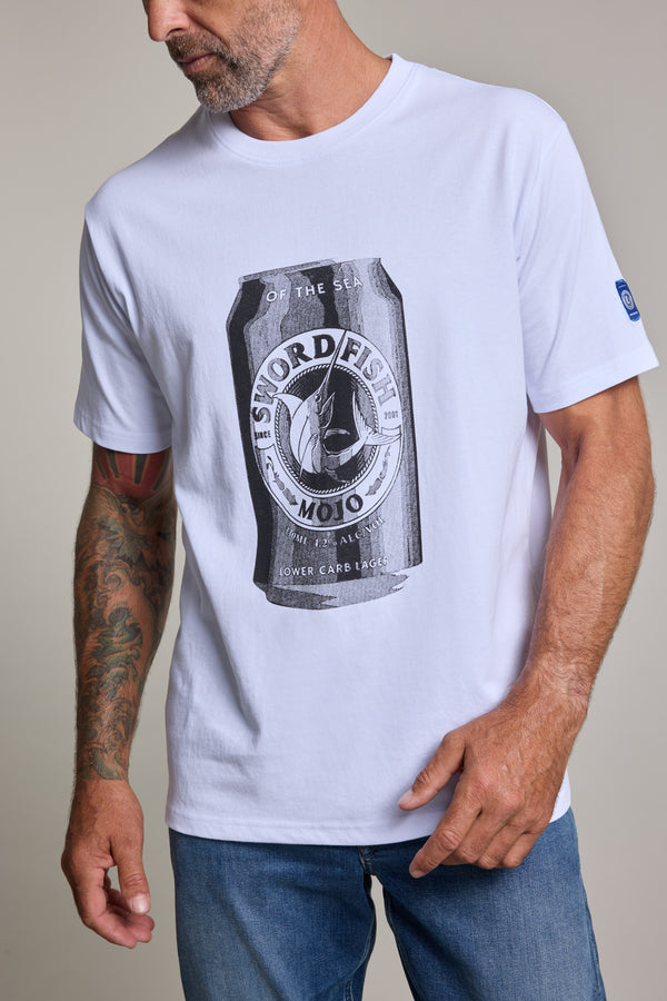 A man wears the Swordfish Mojo Beercan Tee by Swordfish Mojo, made from exclusive organic cotton with a striking black-and-white beercan graphic. He also has a tattoo sleeve on his left arm and pairs the tee with blue jeans.
