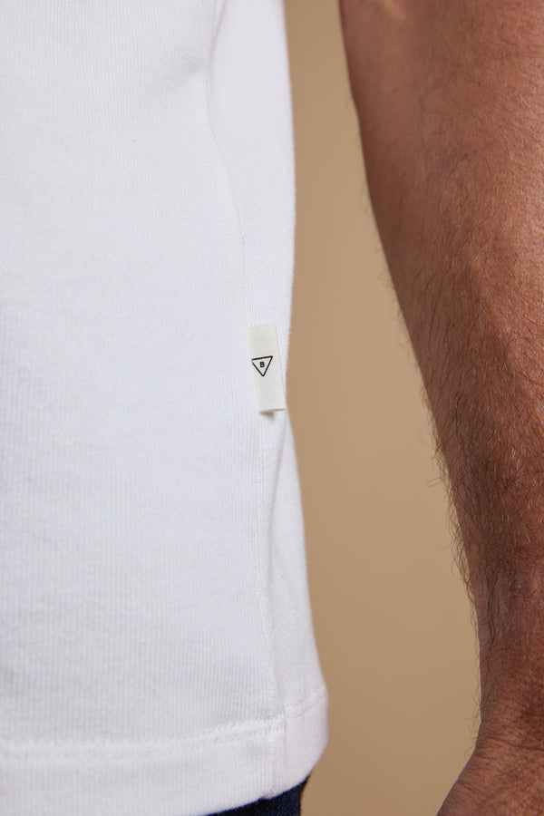 Close-up of the Barkers Langwood Tee with a small triangle tag by the sleeve.