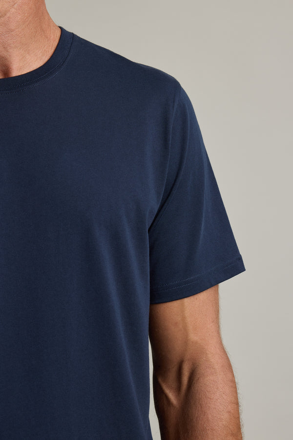 Person wears a Barkers Good Earth Cotton Essential Tee, shown from the shoulder down.