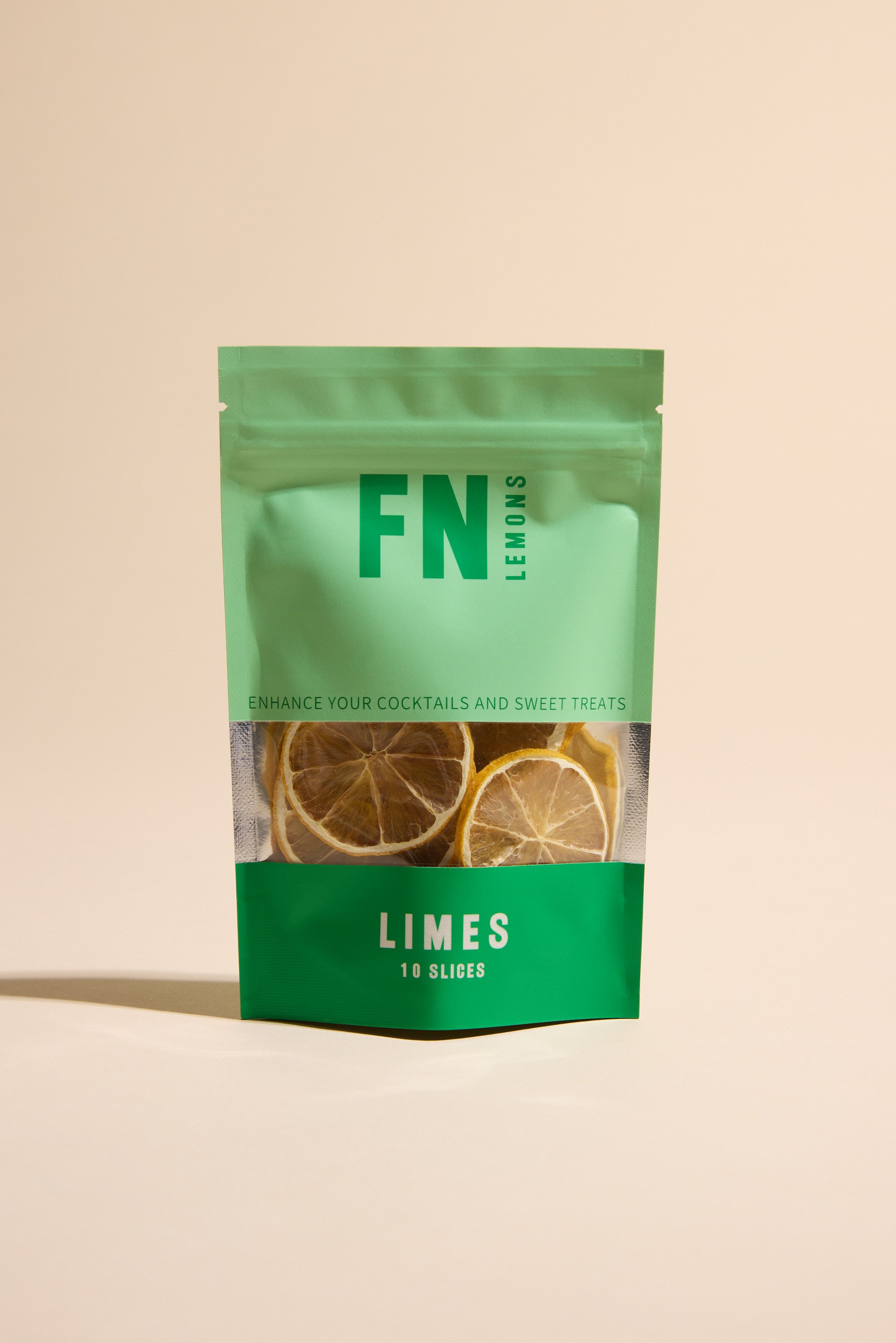 A green and teal F N Lemons - Limes 10 Slice Pouch features dried lime slices visible through a clear window—perfect as a premium garnish for cocktails or baking. Pack enhances your drinks and desserts with F N Lemons quality.