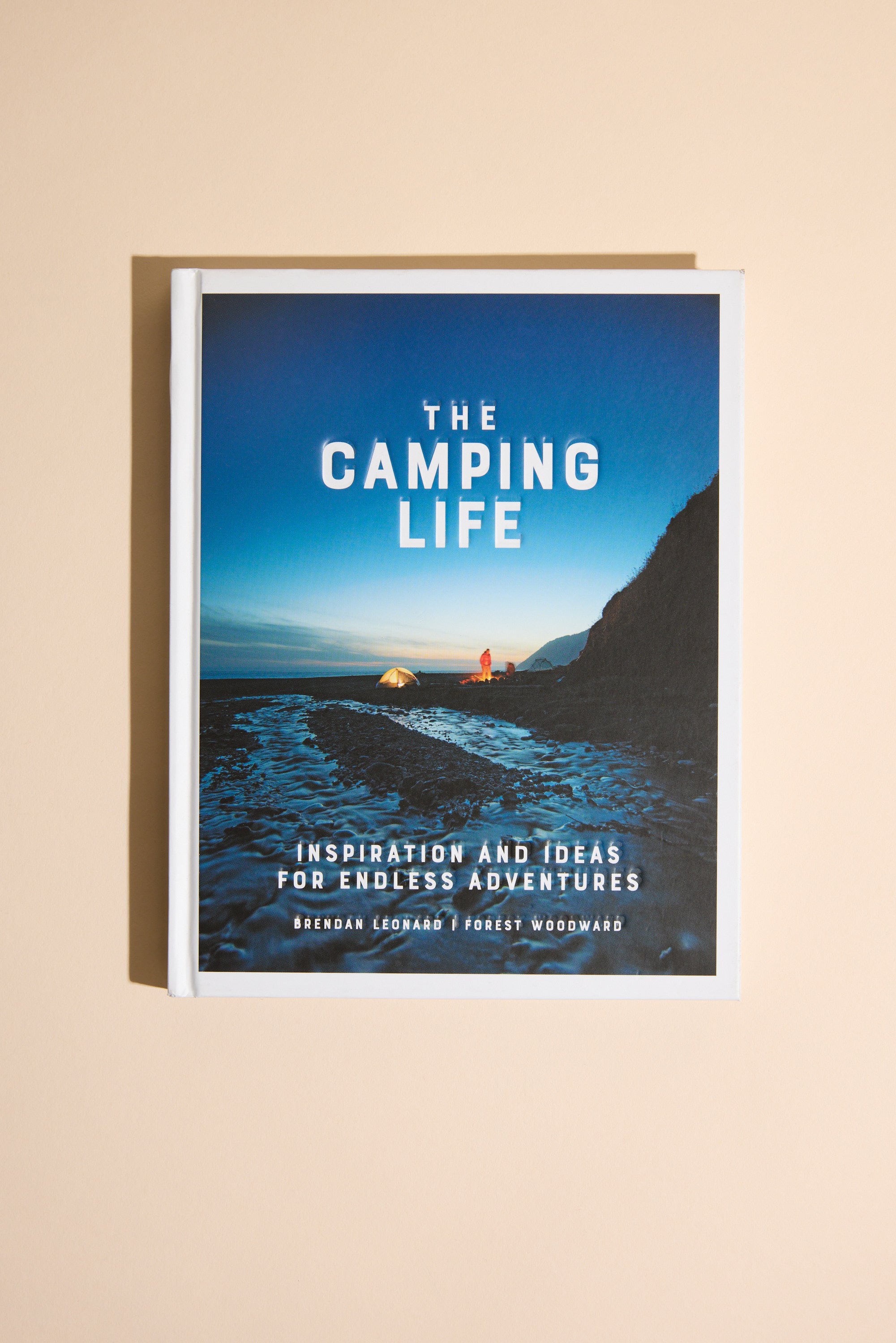 Camping Life by Other features a cover photo of a glowing tent on a rocky New Zealand beach at dusk, with ocean and cliffs in the background. Tagline: Inspiration and Ideas for Endless Outdoor Adventure.