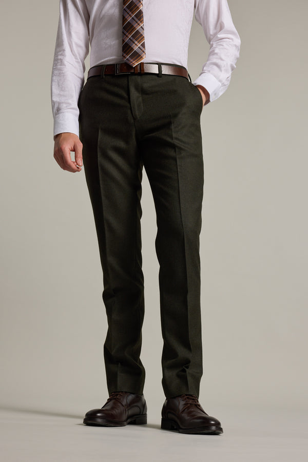 A man models Barkers Howard Suit Trouser, paired with a white dress shirt, patterned tie, and brown dress shoes. He stands with one hand in his pocket against a plain background. His head is not visible in the image.