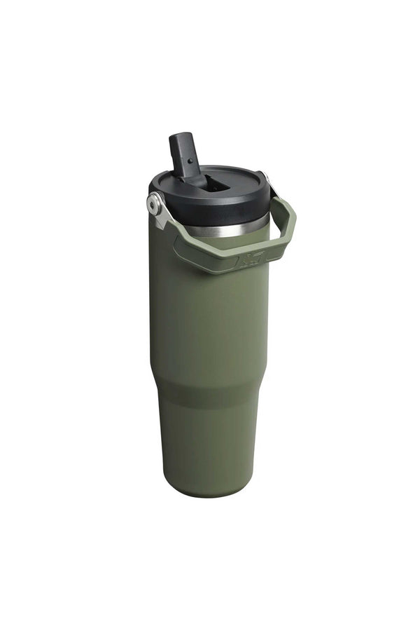 The Stanley IceFlow Flip Straw Tumbler 30 OZ in green features a handle, black flip-top lid, and double-wall vacuum insulation to keep drinks hot or cold. Made from recycled plastics, it stands upright on a white background.