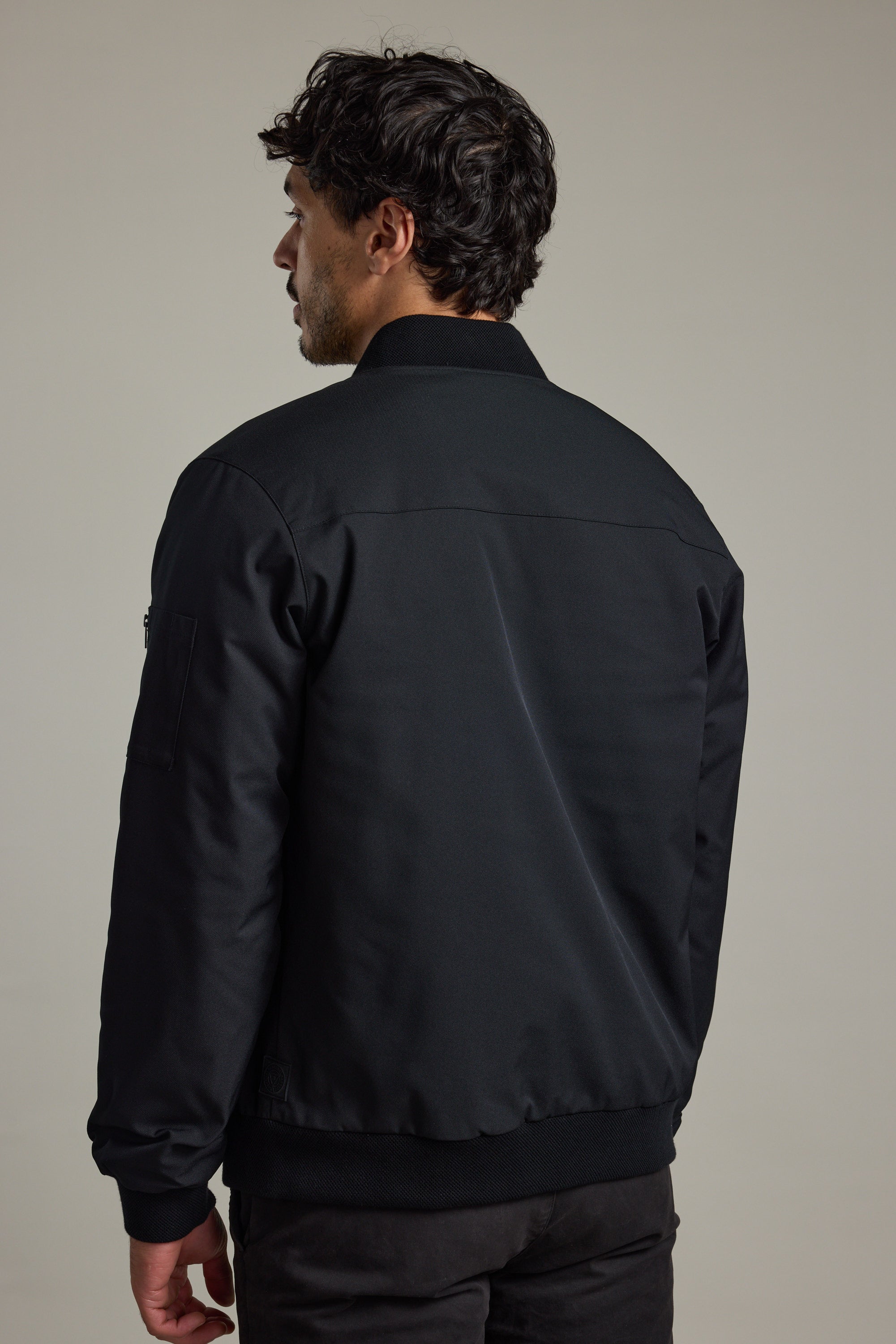A man in a Barkers Dunhill Bomber Jacket, shown from the back against a plain background.