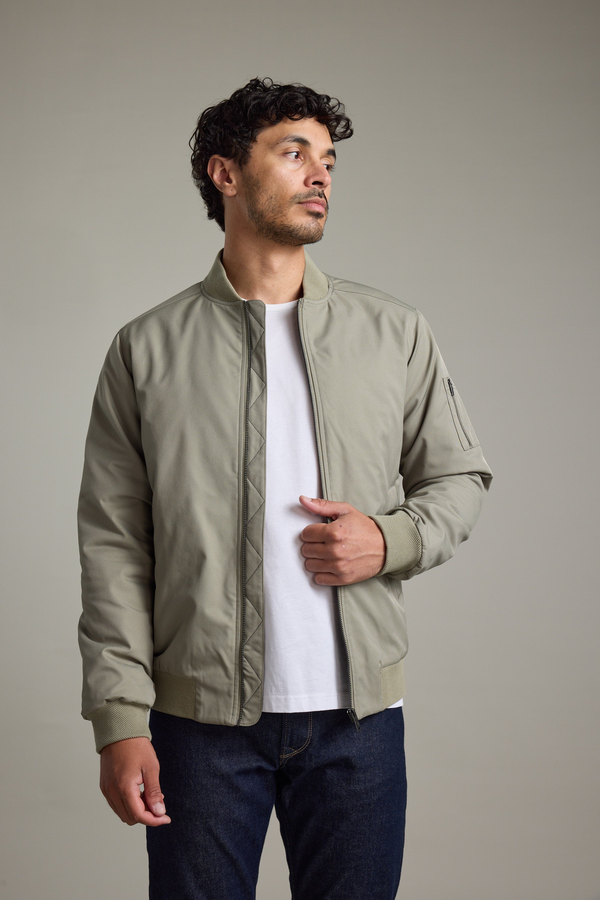 Man in Barkers Dunhill Bomber Jacket and white t-shirt against a plain background.
