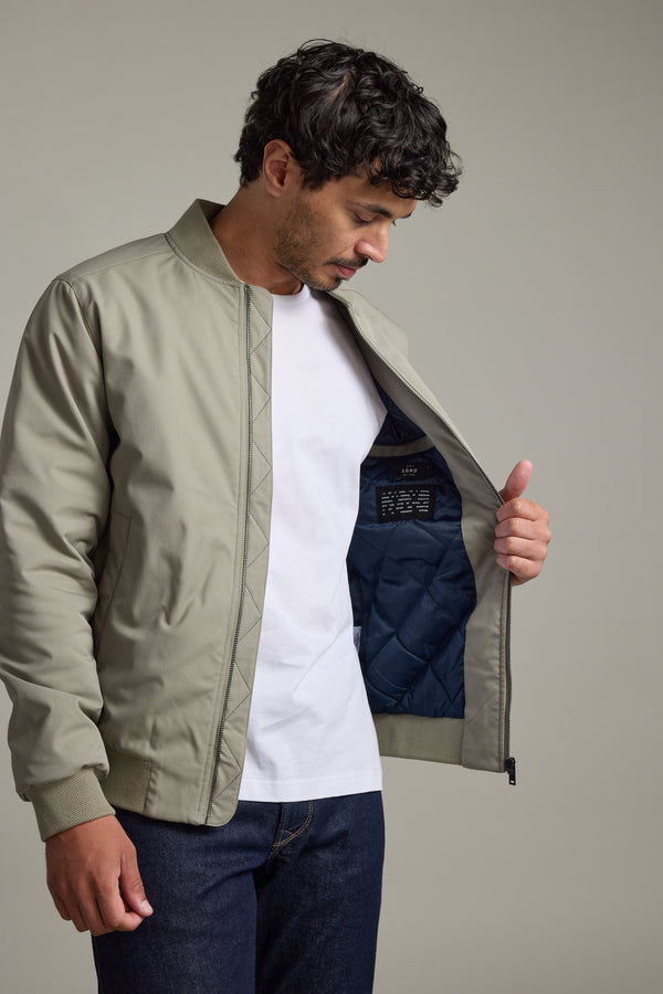 Man in a Barkers Dunhill Bomber Jacket opens it to show its dark quilted lining inside.
