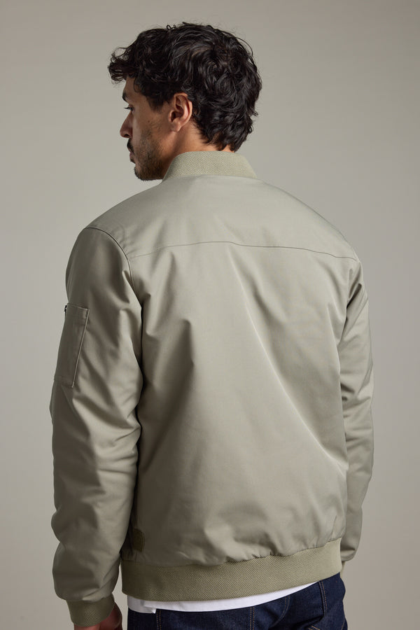 Man in Barkers Dunhill Bomber Jacket, light gray, recycled polyester, shown from the back.