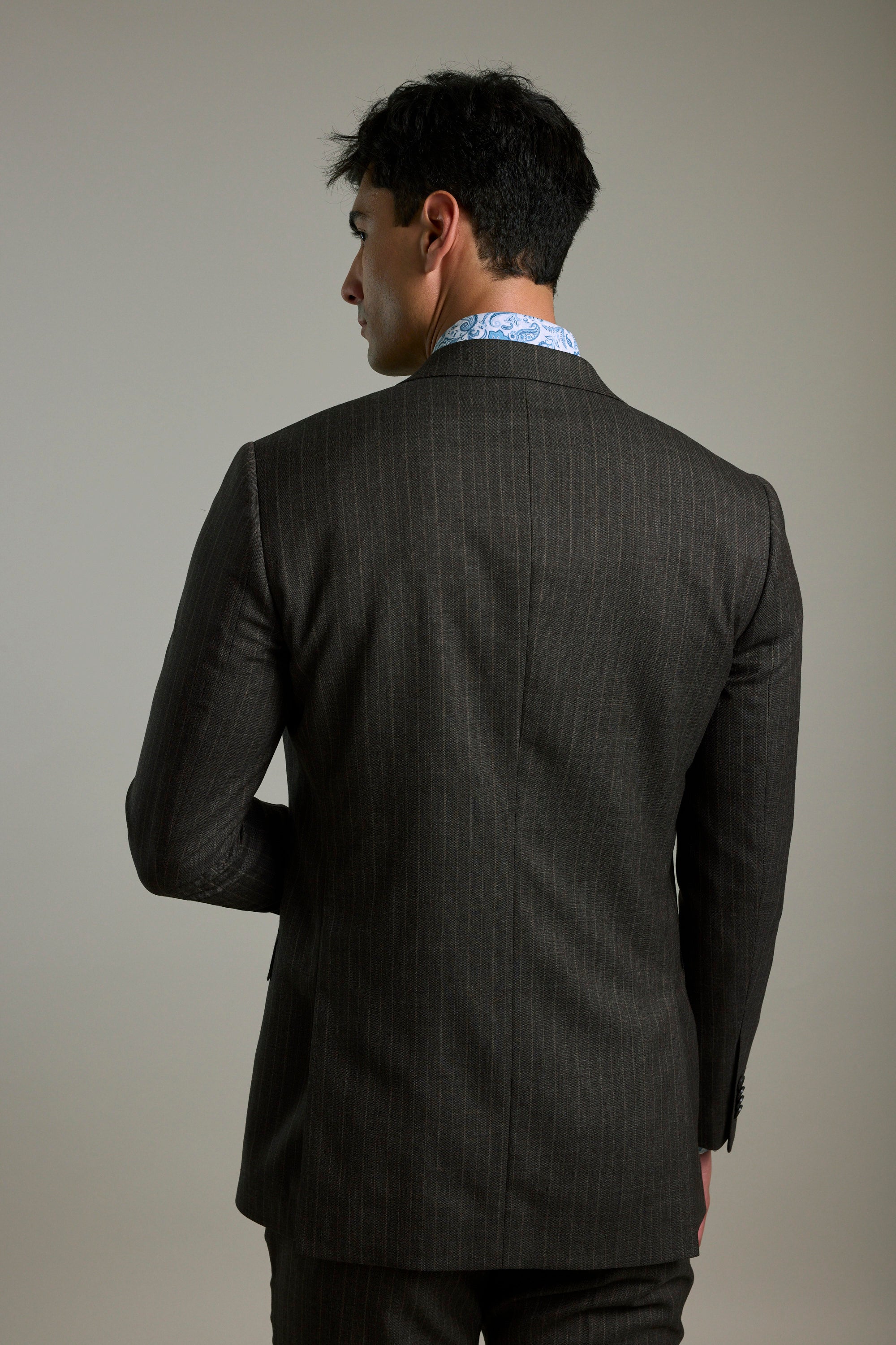 Man in a Barkers Radcliffe Stripe Double Breasted Suit Jacket stands with his back to camera.