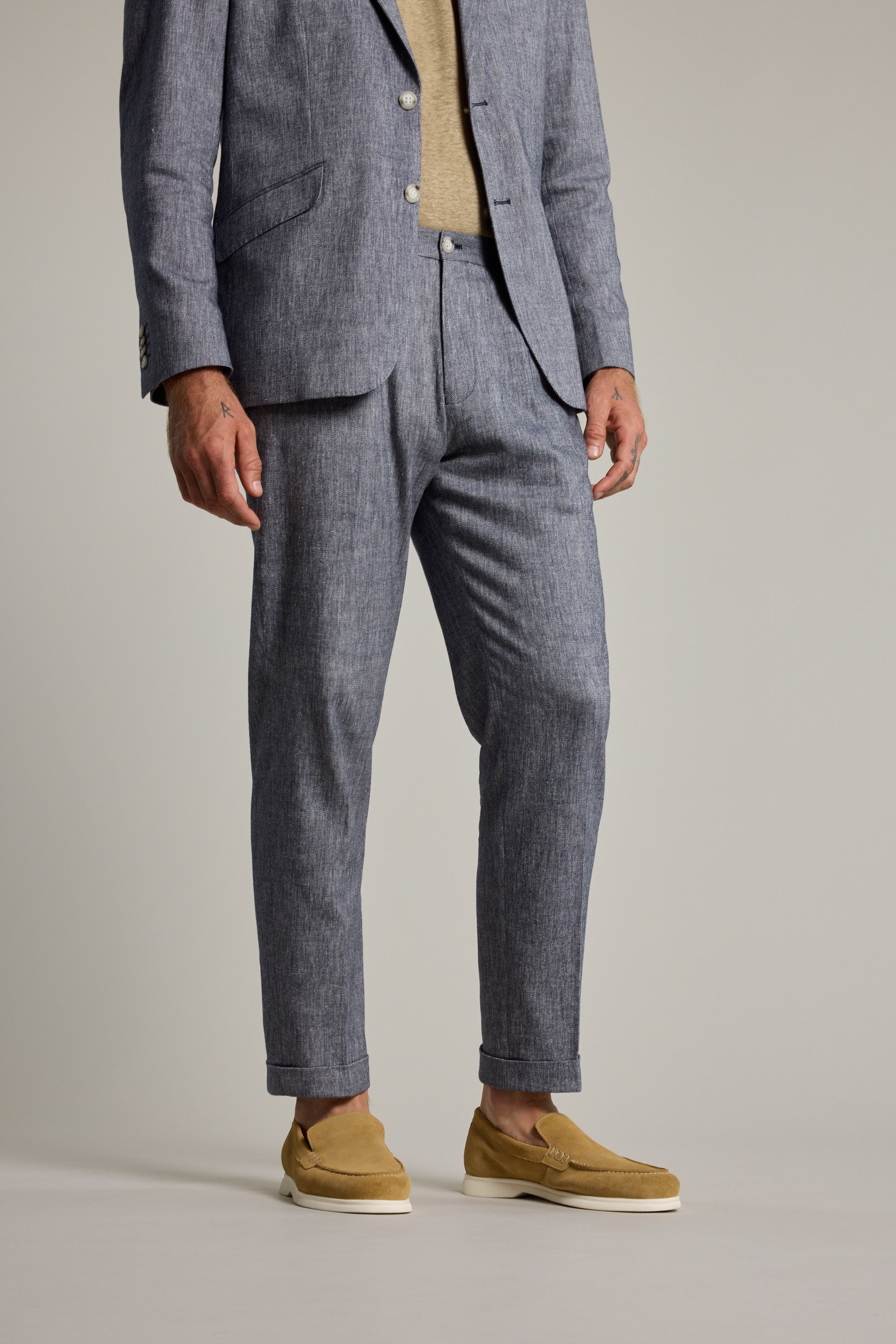 Man in Paden Twill Pant by Barkers, beige shirt, tan loafers, on a plain background.