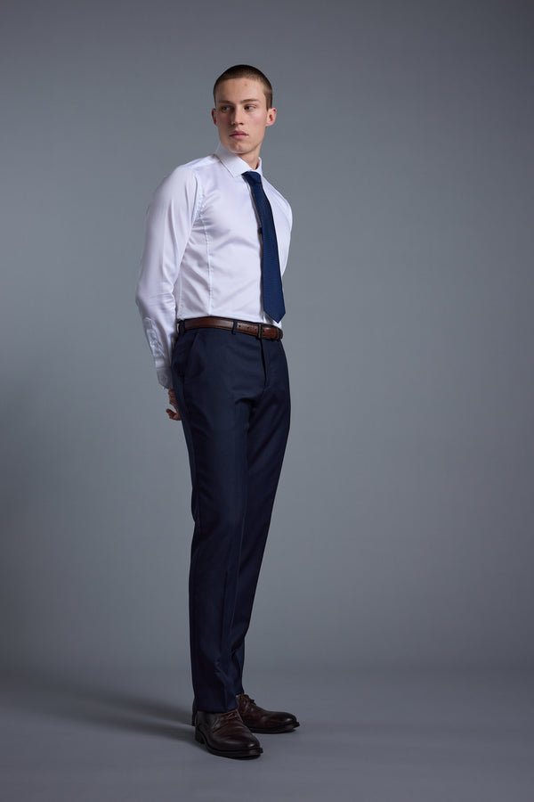 Man in Barkers Mayfair ZQrx Suit Trouser stands against a plain gray background.