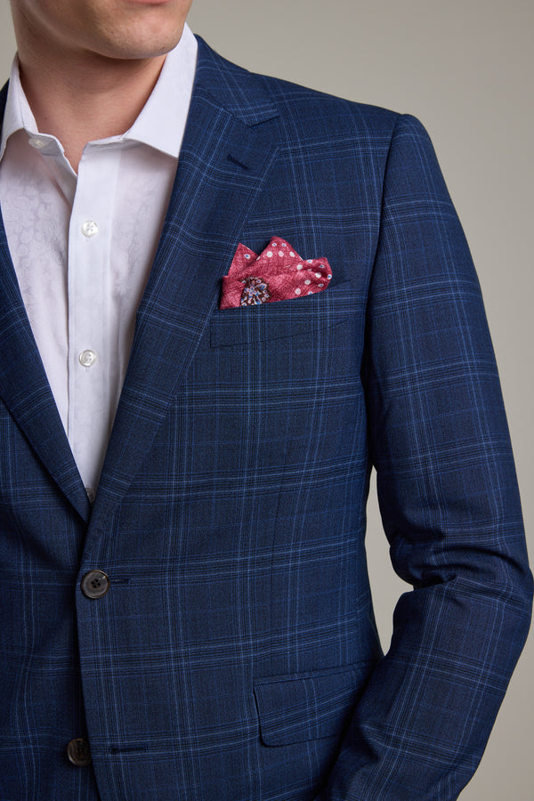 A man wears the Barkers Leonard Check Suit Jacket over a white dress shirt, with a pink patterned pocket square. The image is cropped to show only his shoulders and upper chest.