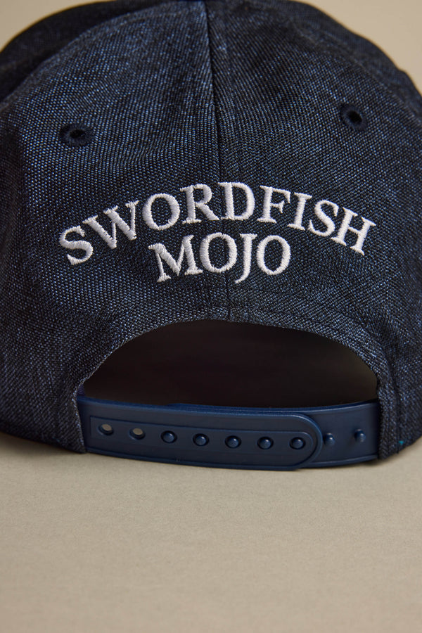 A close-up of the back of the Swordfish Mojo Trucker Cap by Swordfish Mojo shows white embroidered branding above the adjustable strap—a must-have for collectors.
