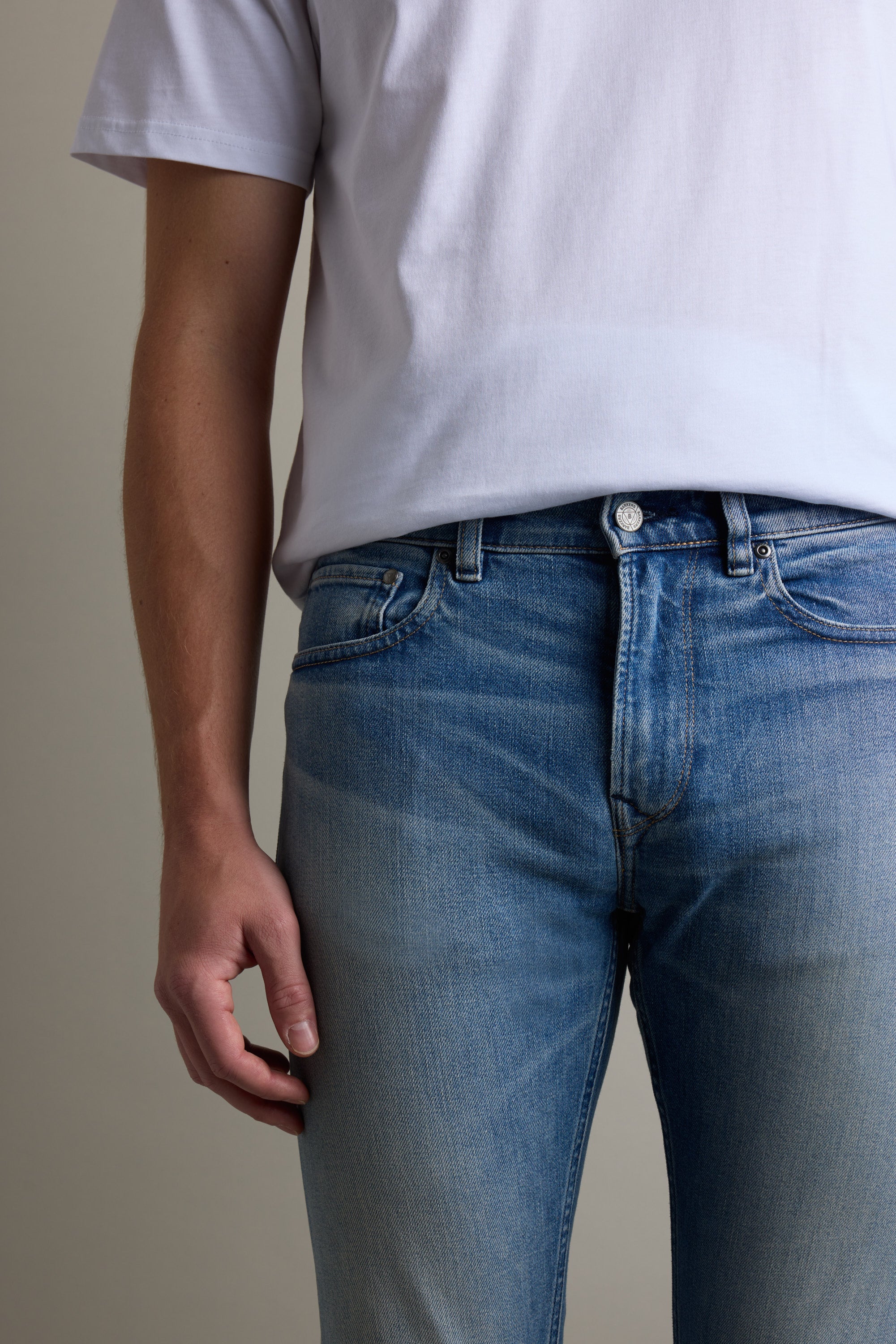 Person in a white t-shirt and Barkers Rambler Denim Slim Jean made from sustainable denim.