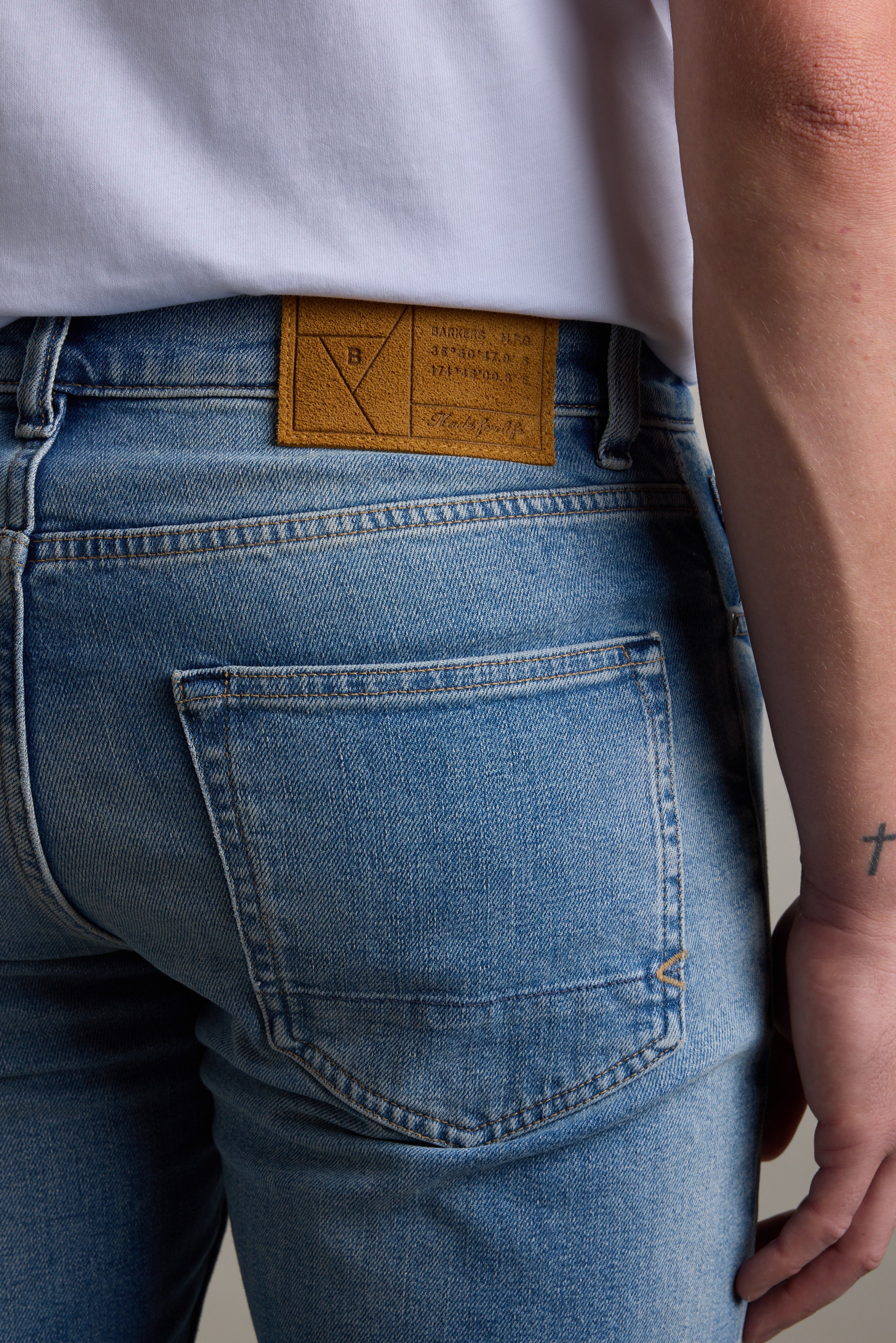 Person wearing Barkers Wanderer Denim Straight Jean, showing back pocket and waistband label.