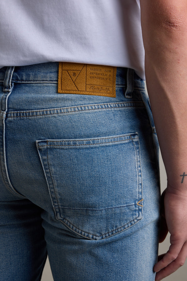 Person wearing Barkers Wanderer Denim Straight Jean, showing back pocket and waistband label.