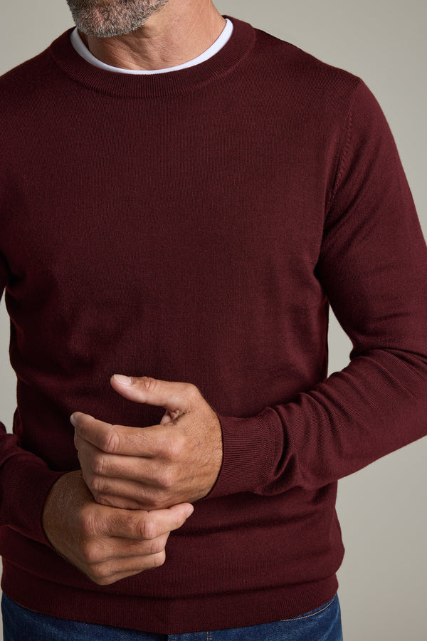 Man wearing Barkers Skyland ZQrx Merino Crew, hands clasped, shown shoulders to waist.