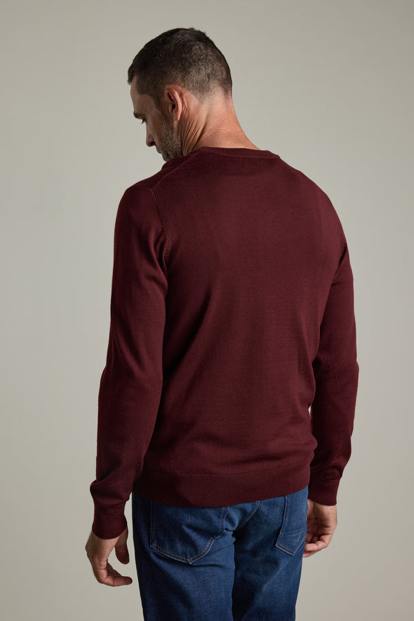 Man in a Barkers Skyland ZQrx Merino Crew and blue jeans, facing away from the camera.