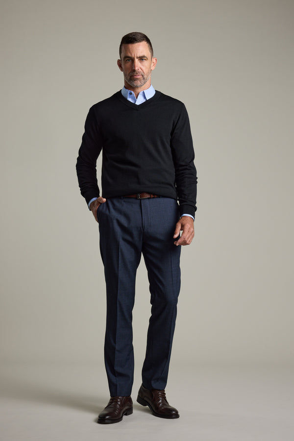 Man in a black Barkers Skyland ZQrx Merino Vee sweater, blue shirt, and dress pants.