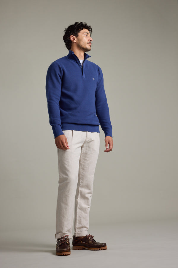 Man wearing Barkers Gaston Cotton 1/4 Zip Sweater and beige pants against a plain background.
