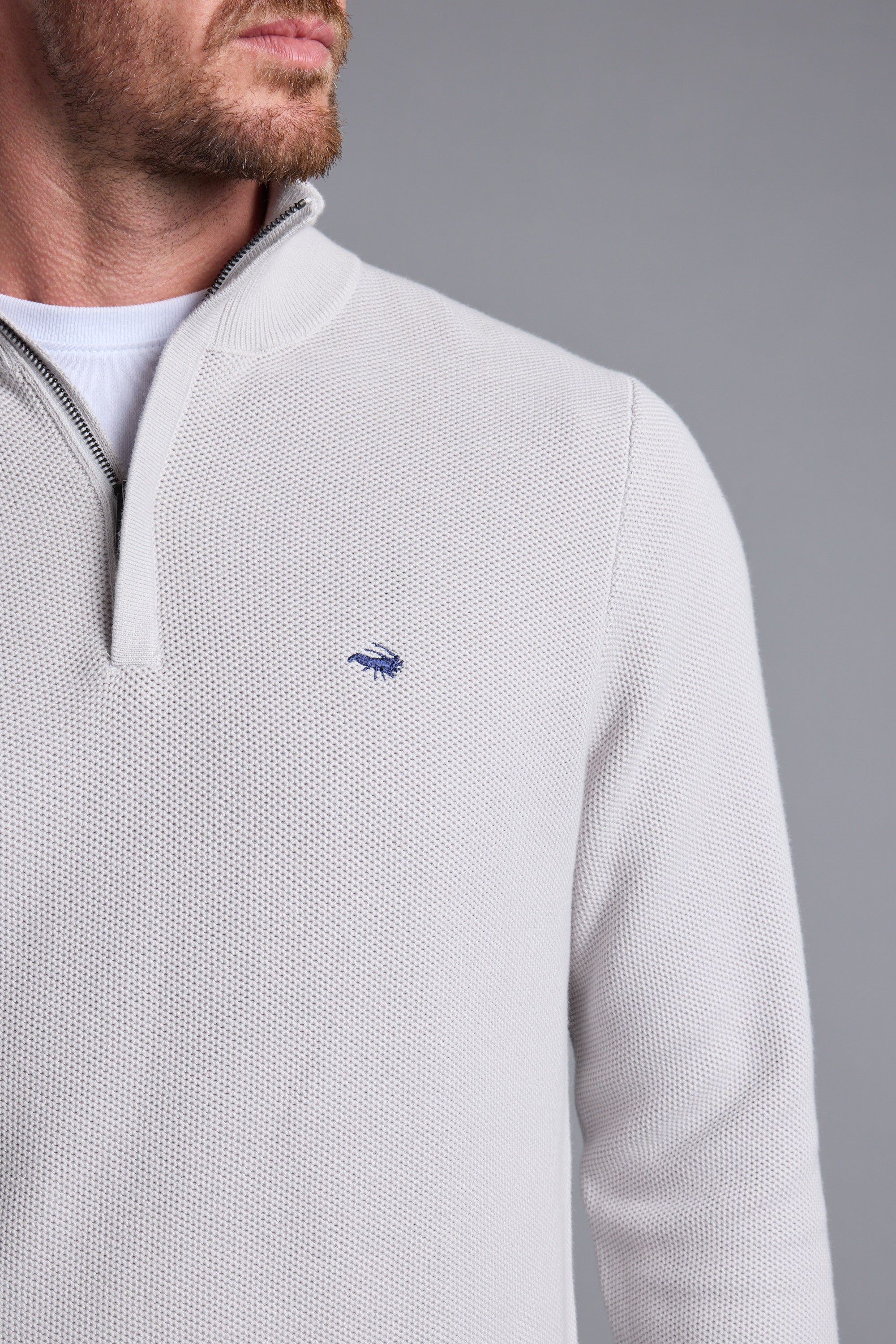 Man wearing a light gray Barkers Gaston Cotton 1/4 Zip Sweater, responsibly sourced cotton.