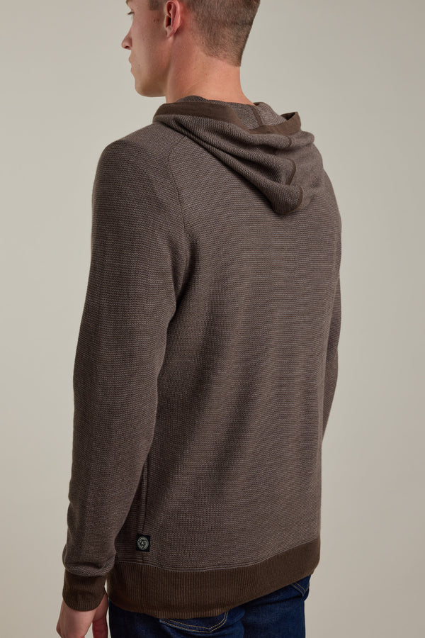 A person is shown from the back wearing the Barkers Roxbury Merino Hoody against a plain light background. The lightweight sweater features a textured knit pattern and ribbed cuffs and hem.