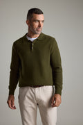 Man in Barkers Ainsley Woollen Long Sleeve Polo and light pants looks to the left.