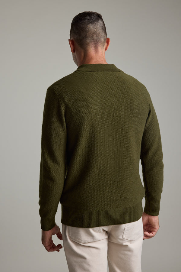 Man wearing Barkers Ainsley Woollen Long Sleeve Polo in olive, shown from the back.