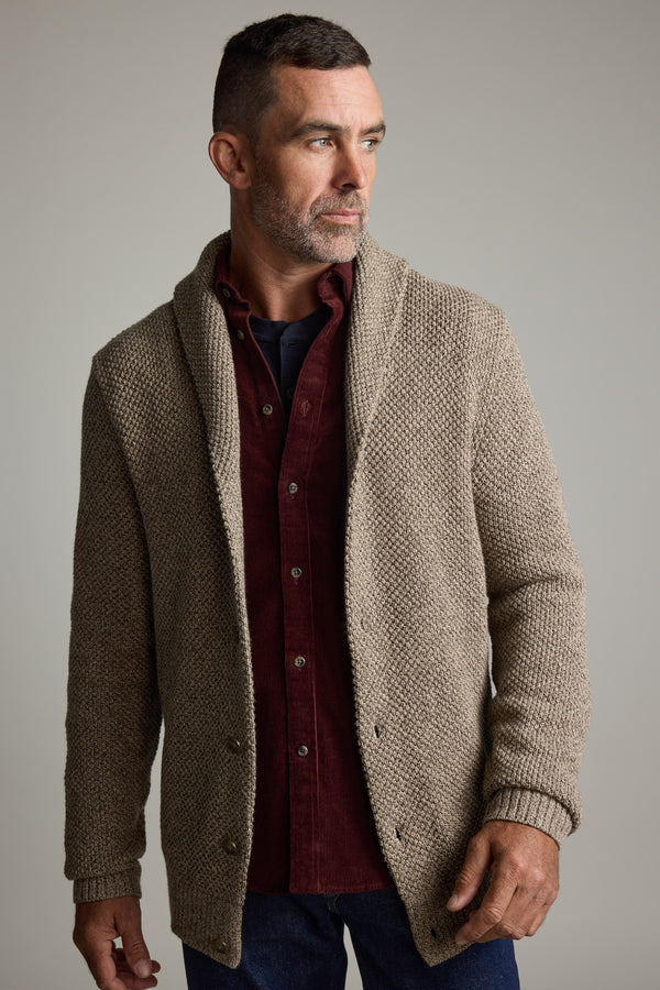 Man wears Rudder Cotton Shawl Cardi by Barkers over maroon shirt, ideal for winter layering.